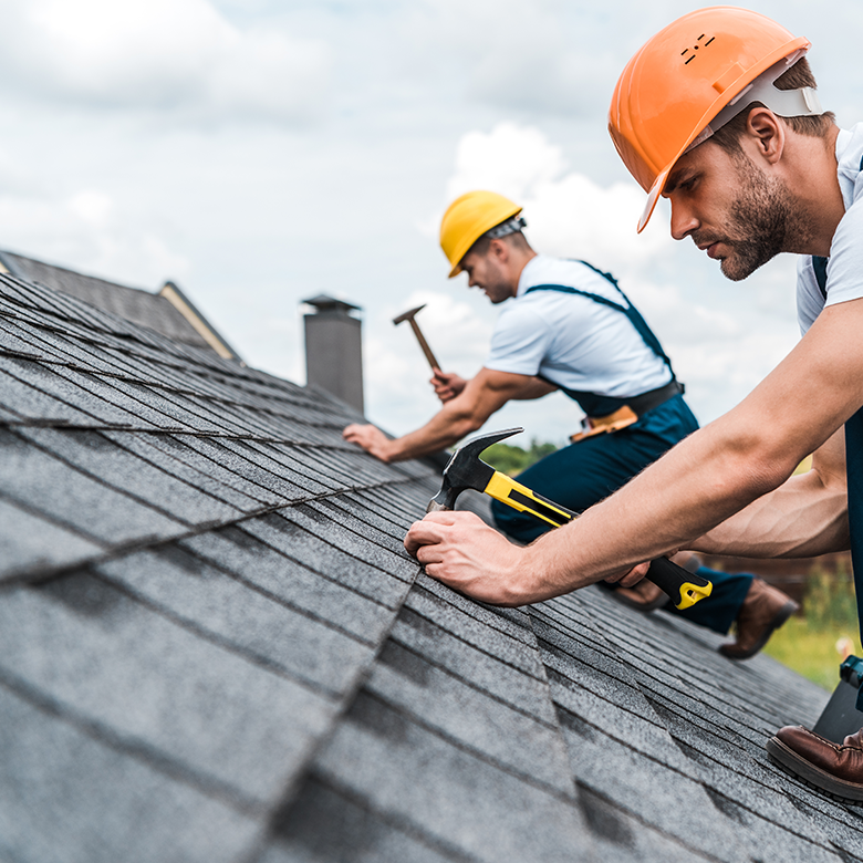 Roofers installing asphalt shingles