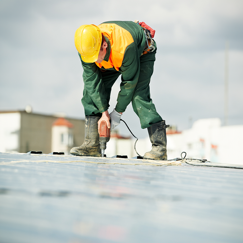 Roofer working on commercial roof